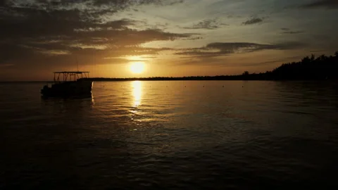The boat rocks on the waves in the rays of the sunset Stock Footage 90759458