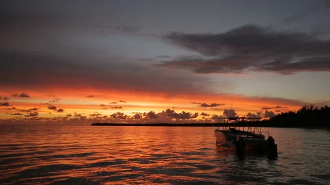 The boat rocks on the waves in the rays of the sunset Stock Footage 90801589