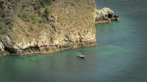 Boat at the rocky coast Stock Footage 12128451