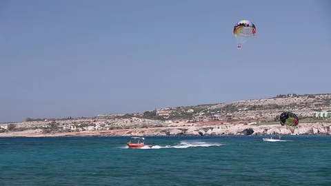 The boat rolls a man on a parachute, Sea entertainment, beautiful coast, good Stock Footage