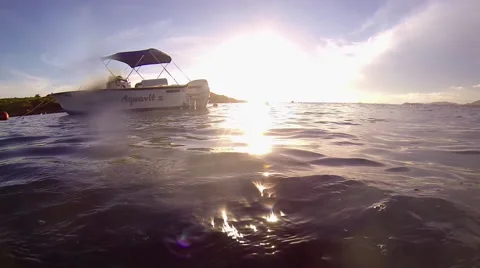Boat rolls in the waves with sun behind it Stock Footage 42444151