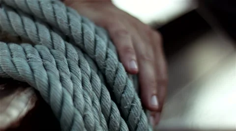A boat rope with a man hand Stock Footage 62473529