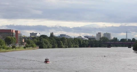 Boat, rower and train on Main River with a plane overhead Stock Footage 320030005
