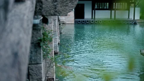 Boat rowing under the bridge in Chinese classic garden Stock Footage 274295325