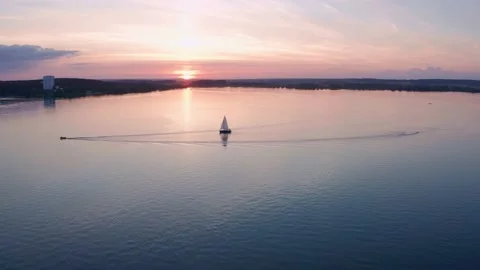 Boat with sail on the sunset on the water surface, shot on drone. Close-up. Stock Footage 231794846