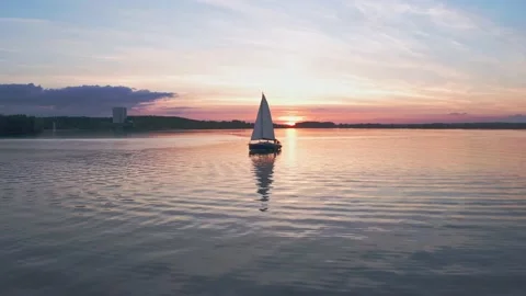 Boat with sail on the sunset on the water surface, shot on drone. Close-up. Stock Footage 231795247