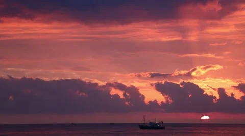 Boat sailing across the sunset skyline Stock Footage