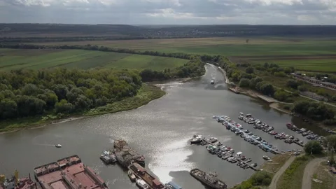 The boat is sailing into the bay of the river with a technical base. Stock Footage 145932597