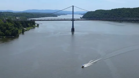 Boat sailing on hudson river with view of mid hudson bridge distant mountains Video stock 278051200