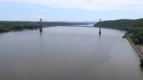 Boat sailing on hudson river with view of mid hudson bridge distant mountains Video stock 278051369