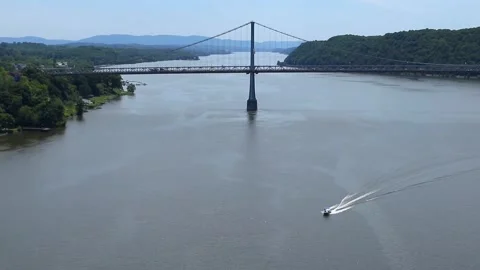Boat sailing on hudson river with view of mid hudson bridge distant mountains Video stock 278054148