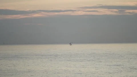 The boat is sailing in the middle of the ocean in the dusk Stock Footage 255998301