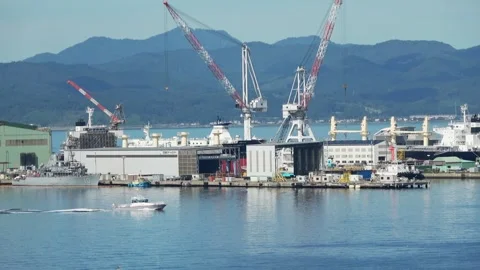 Boat sailing past shipyard cranes, Hakodate, Japan, 2026.09.10. Vídeo Stock 345364493
