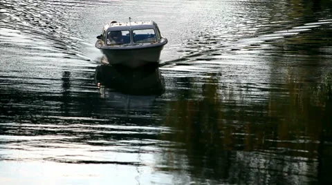 Boat sailing in the river with water reflection and a lonely man on the boat Stock Footage 44061853