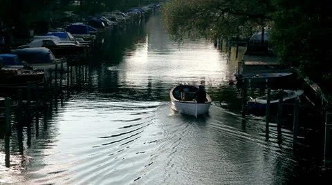 Boat sailing in the river with water reflection and a lonely man on the boat Stock Footage 45045288