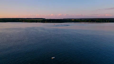 Boat sailing at sunset. Evening river landscape on industrial factory background Stock Footage 135396019
