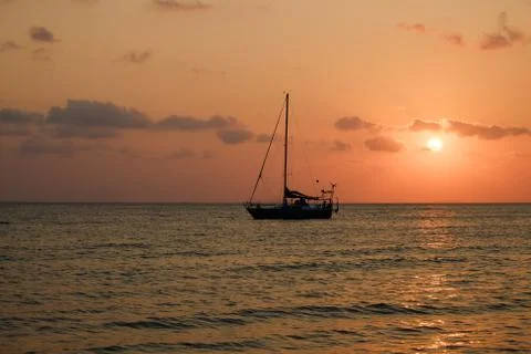 Boat sailing sunset Stock Photos