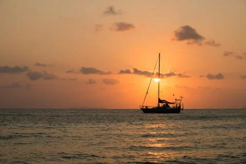 Boat sailing sunset Stock Photos
