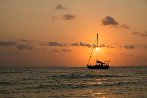 Boat sailing sunset Stock Photos