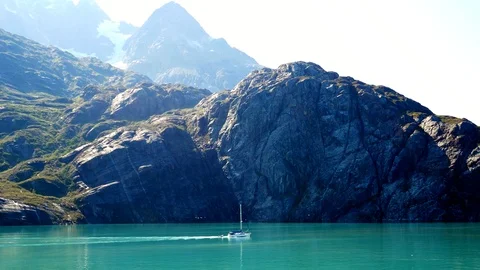 A boat sailing through the calm waters of Glacier Bay National Park Stock Footage 121407934