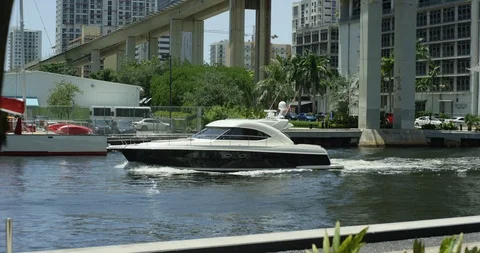 Boat sailing through cityscape Stock Footage 96913019