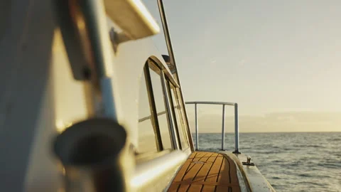 Boat Sailing Through the waves into the Sunset 4K Stock Footage 263284483