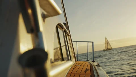 Boat Sailing Through the waves at Sunset Towards Another Sailing Boat 4K Stock Footage 263284489