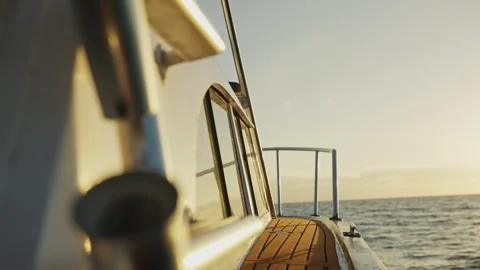 Boat Sailing Through the waves into the Sunset 4K Stock Footage 263285332