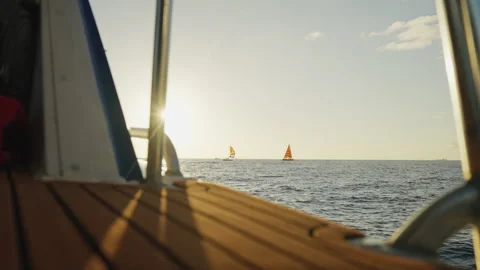 Boat Sailing Through Waves Towards Boats Sailing Near the Sunset 4K Stock Footage 263282755