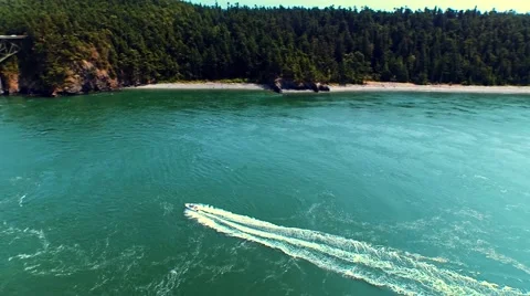Boat sailing toward a bridge by oceanfront on a sunny day Stock-Footage 53307128