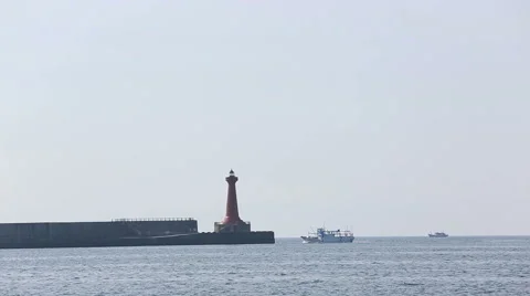Boat sailing under guide of the lighthouse Stock Footage 52528306