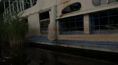 Boat sails to abandoned ship Stock Footage 68944463