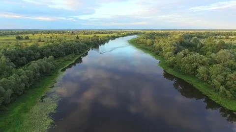 The boat sails along a beautiful river in which clouds are reflected. Aerial. Stock-Footage 82668971