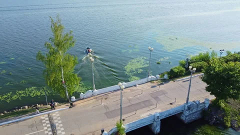 Boat sails along the river under the bridge Stock Footage 281247266