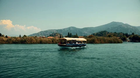 The boat sails between the mountains on the river Video stock 95000086
