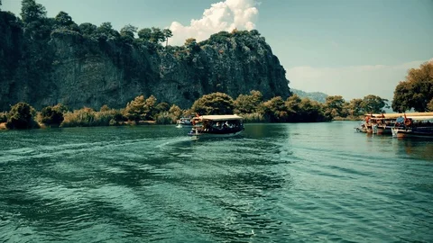 The boat sails between the mountains on the river Stock Footage 95001246