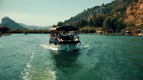 The boat sails between the mountains on the river Stock Footage 95001356