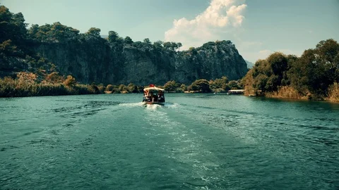 The boat sails between the mountains on the river Stock Footage 95001519