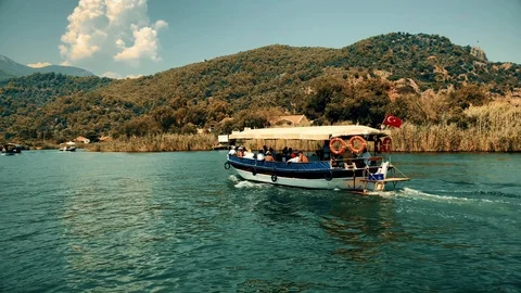 The boat sails between the mountains on the river Stock Footage 95001699