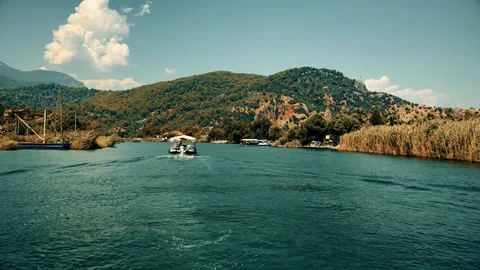 The boat sails between the mountains on the river Stock Footage 95001841