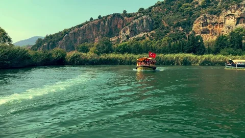 The boat sails between the mountains on the river Stock Footage 95003347