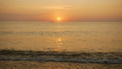 The boat sails in the distance against the backdrop of the sunset Stock Footage 147597533