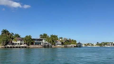 Boat sails in front of Venetian Islands. Luxury houses. Miami, Florida Stock Footage 339072245