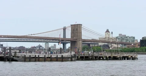 Boat sails past Pier 11 Ferry Terminal on the East River in Manhattan Video stock 77745317