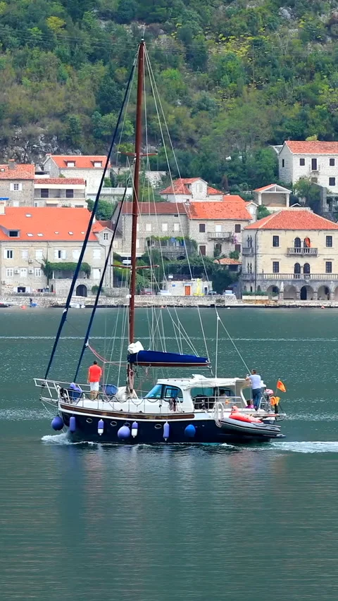 A boat sails before the Perast, old town in Montenegro Stock Footage 293156378