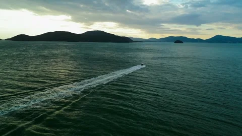 The boat sails into the sea at sunset Stock Footage 273978049