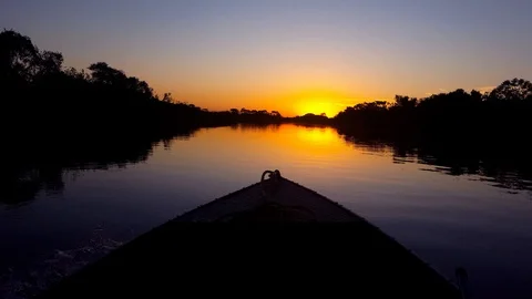 Boat sails towards the sun. Image in the Pantanal Biome. Stock Footage 100116183