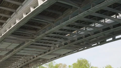 A boat sails under the metal structures of a bridge over the Seine River, Paris. Stock Footage 308724559