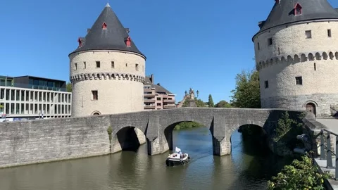 Boat sails under the stone bridge between Broel towers. Kortrijk, Belgium Stock Footage 251637100
