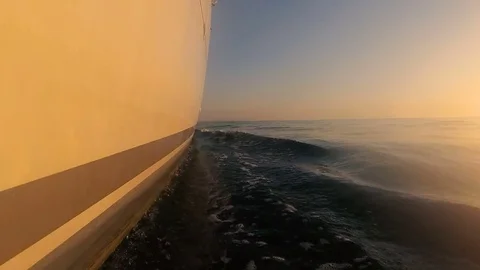 The boat sails on the waves at sunset. Stock Footage 82806722